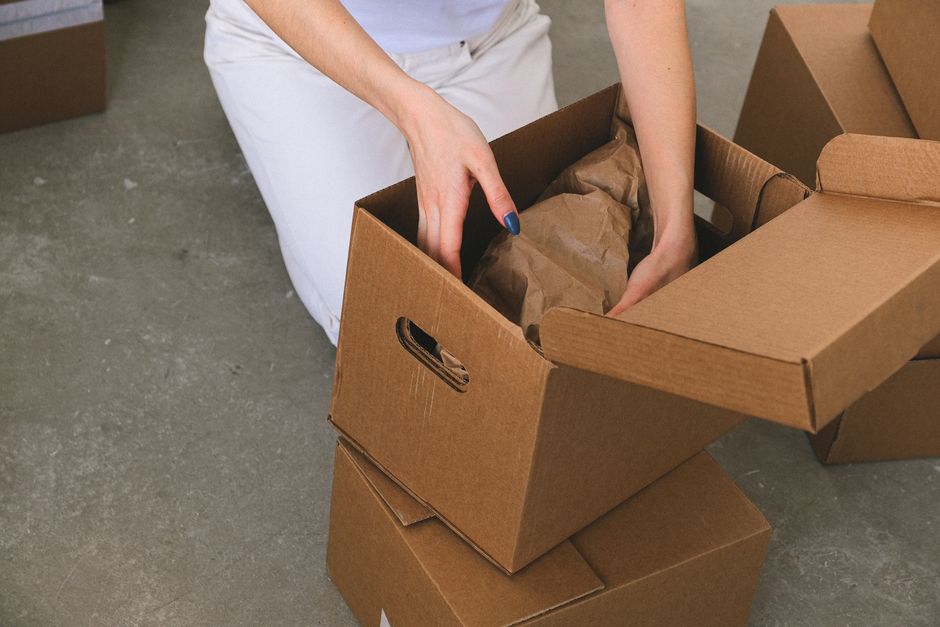 Professional packers boxing household items securely