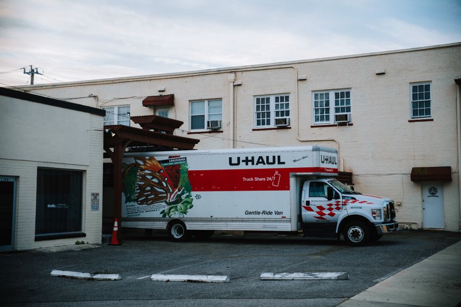 Local movers loading a moving truck with furniture
